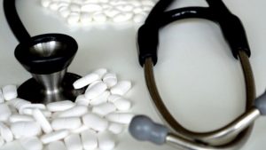 pills and stethoscope in a place